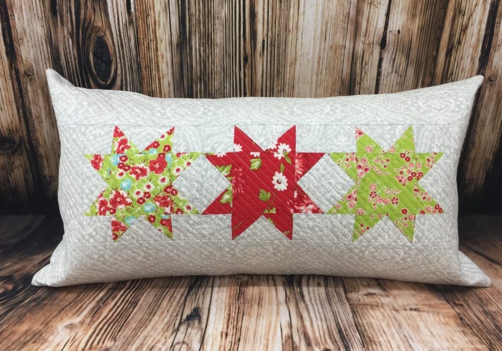 White pillow with three red and green stars
