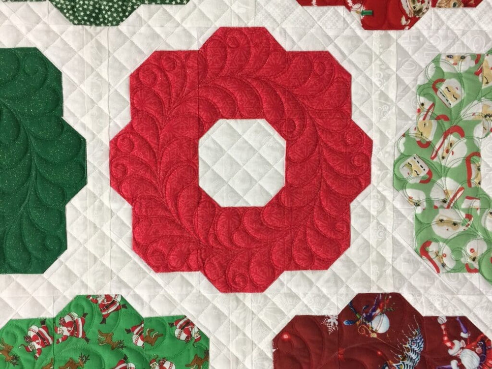 Red octagonal Christmas quilt block with prints