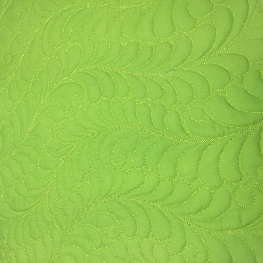 Lime green quilted fabric with feather pattern