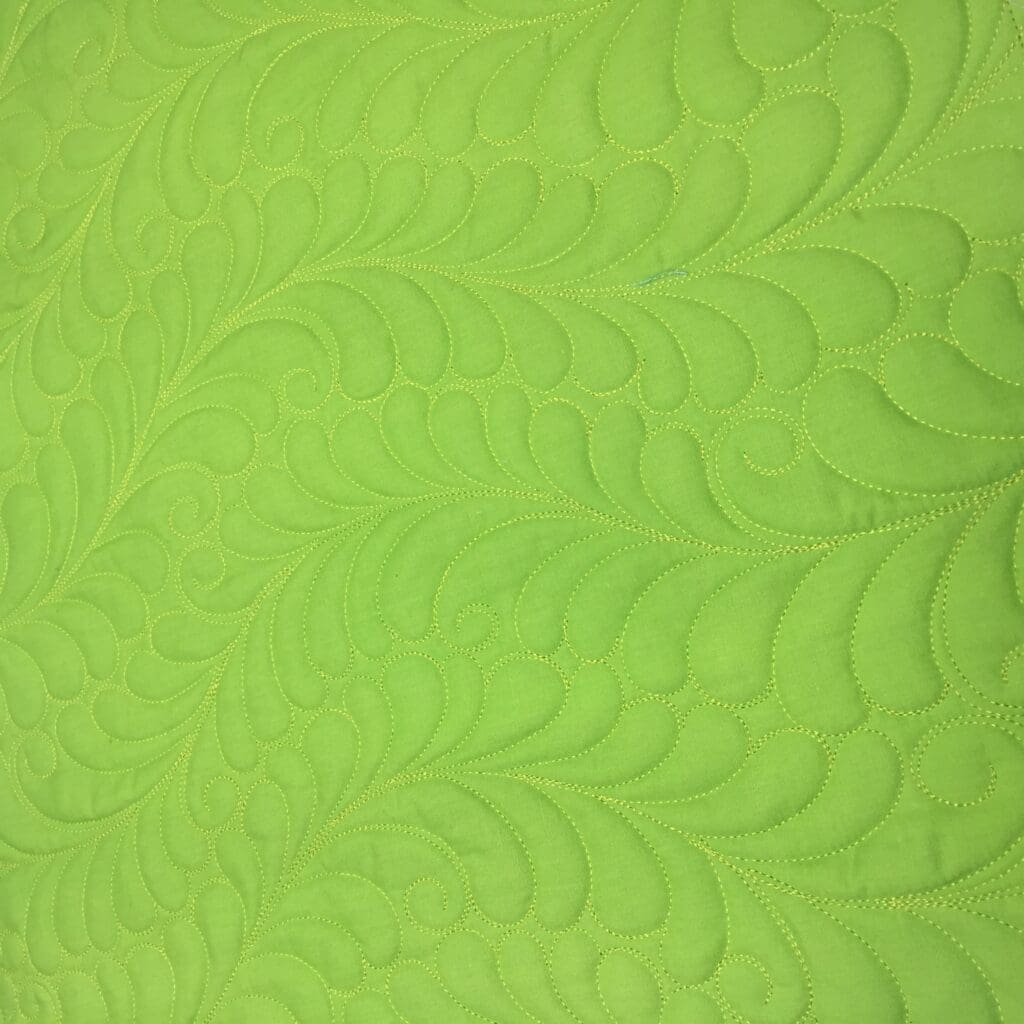 Lime green quilted fabric with feather pattern