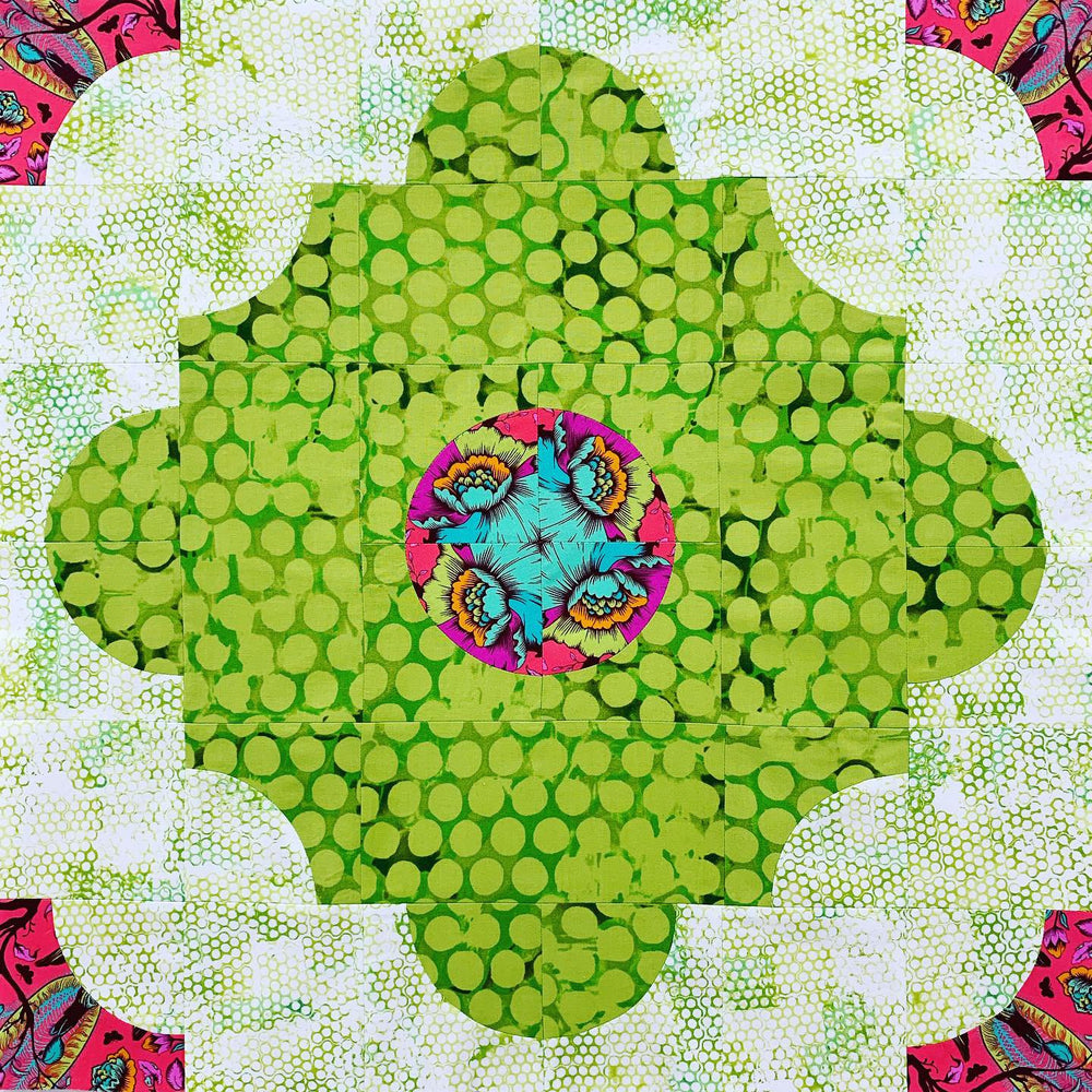 A green and pink flower with many circles