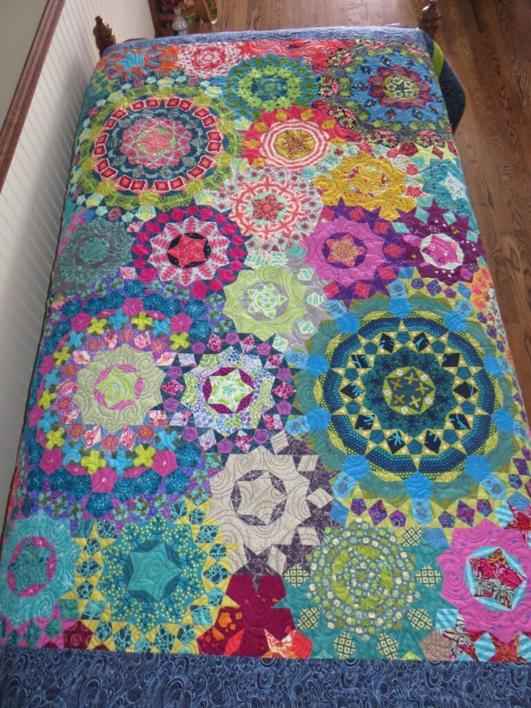 Colorful circular patchwork quilt on bed