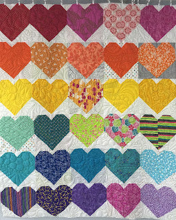 Rows of colorful heart patchwork quilt