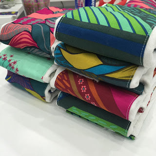 Stack of colorful patterned cloth diapers