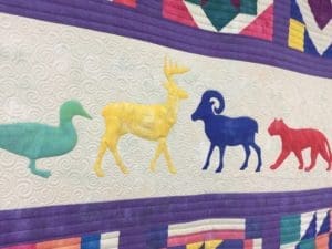 Quilt with colorful animal silhouettes