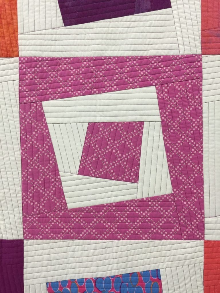 Pink patterned quilt block with white strips