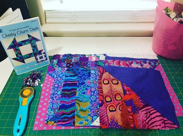 A book and some fabric sitting on top of a table.