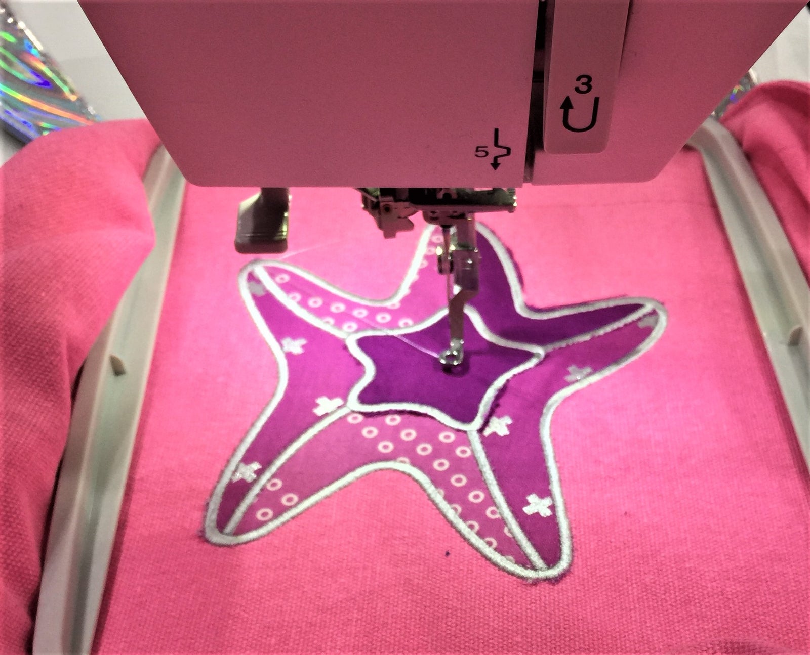 A pink machine with a purple star on it.