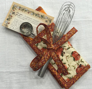 Quilted floral utensil pouch with whisk and spoon
