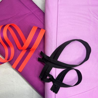 A pair of scissors and a purple cloth