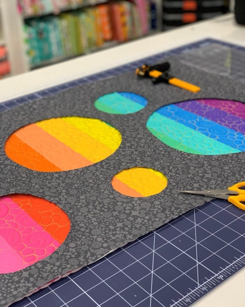 Colorful quilting fabric circles on cutting mat