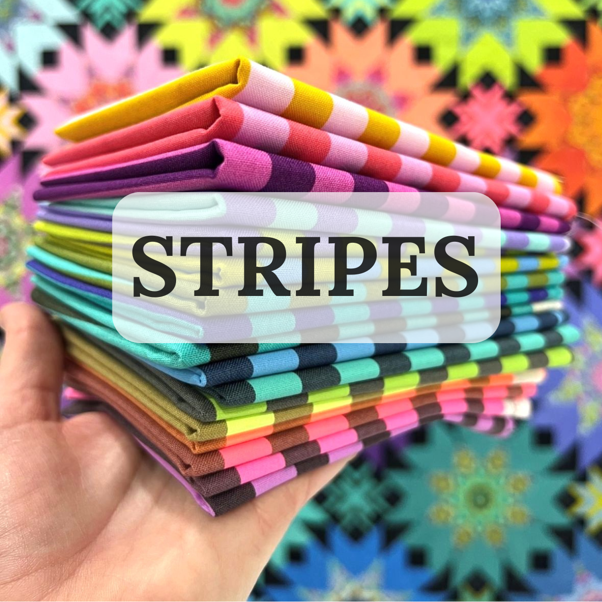 a hand holding a bundle of stripped fabrics with the word Stripes on it