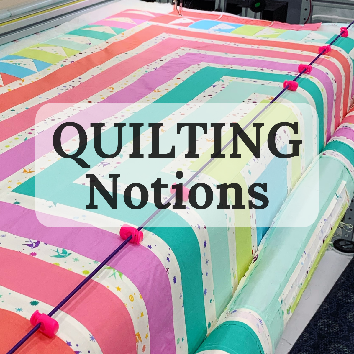 Brightly colored quilt with the words Quilting Notions 