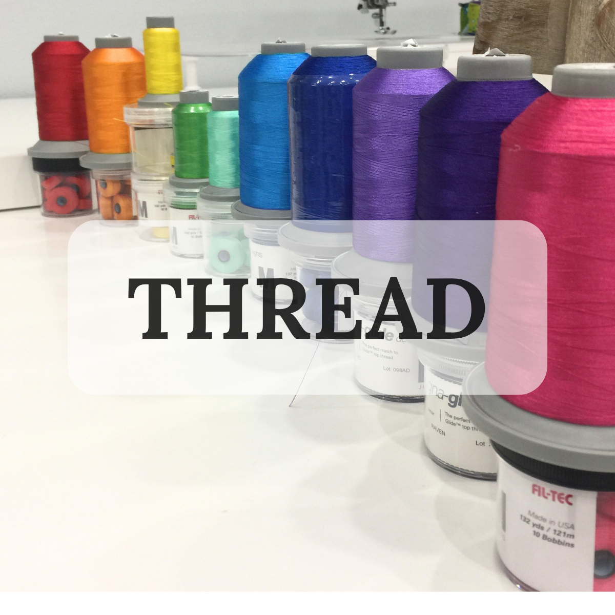 image of brightly colored large spools of thread with the word thread overlayed