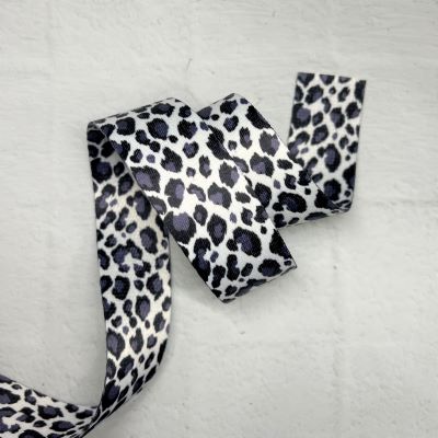 A black and white leopard print ribbon on a table.