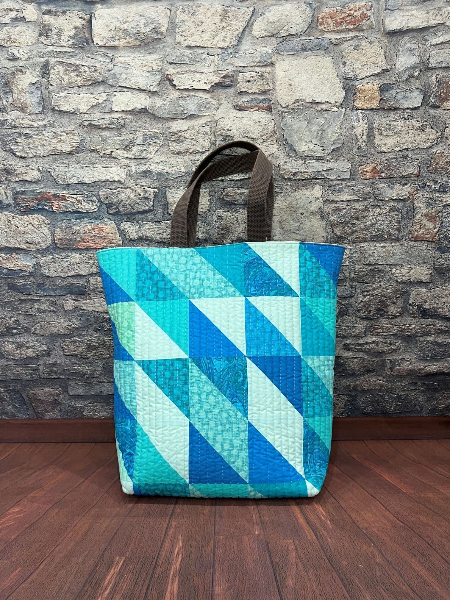 A blue bag sitting on top of a wooden floor.