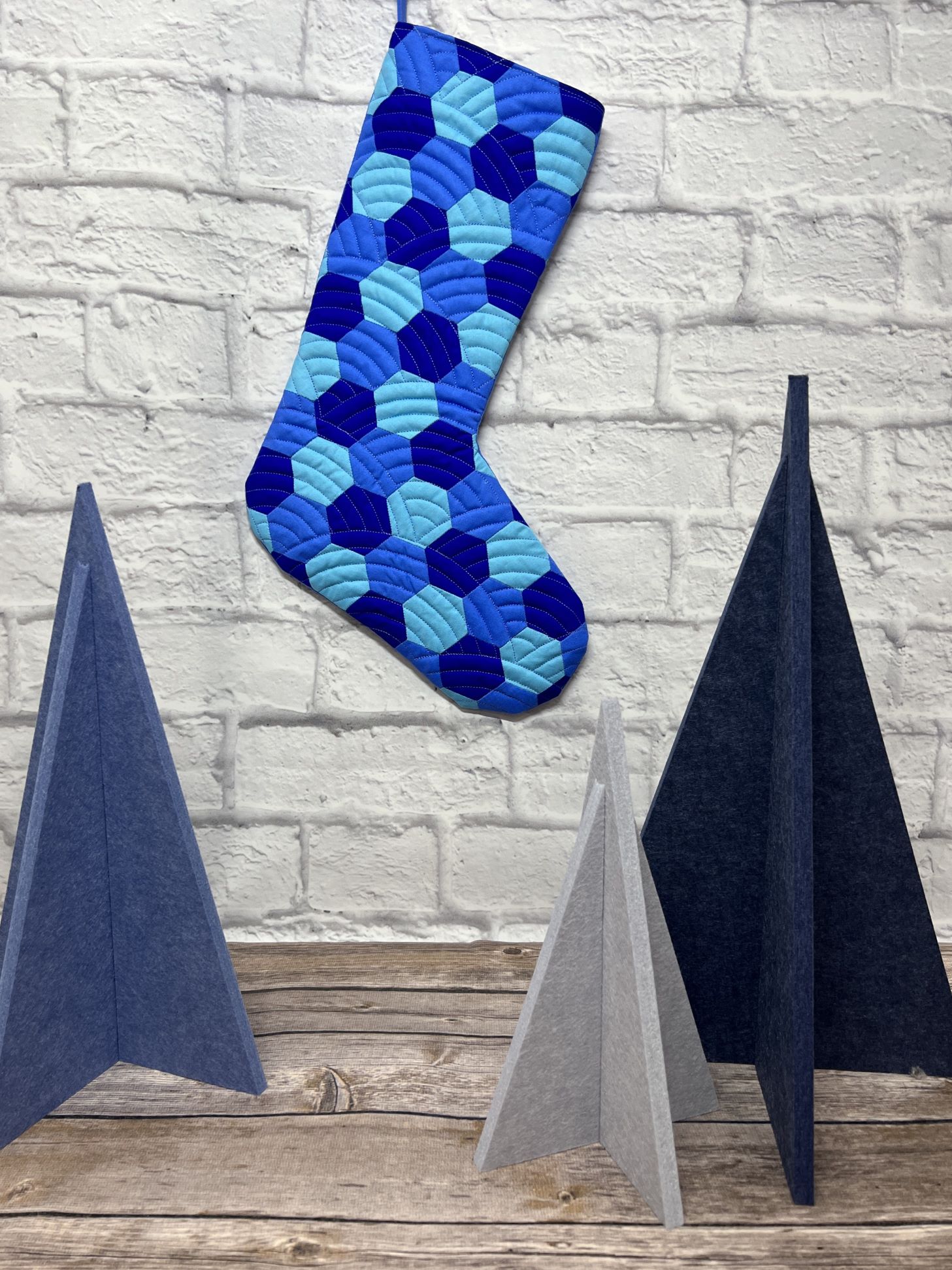 A blue stocking with circles and dots hanging from it.