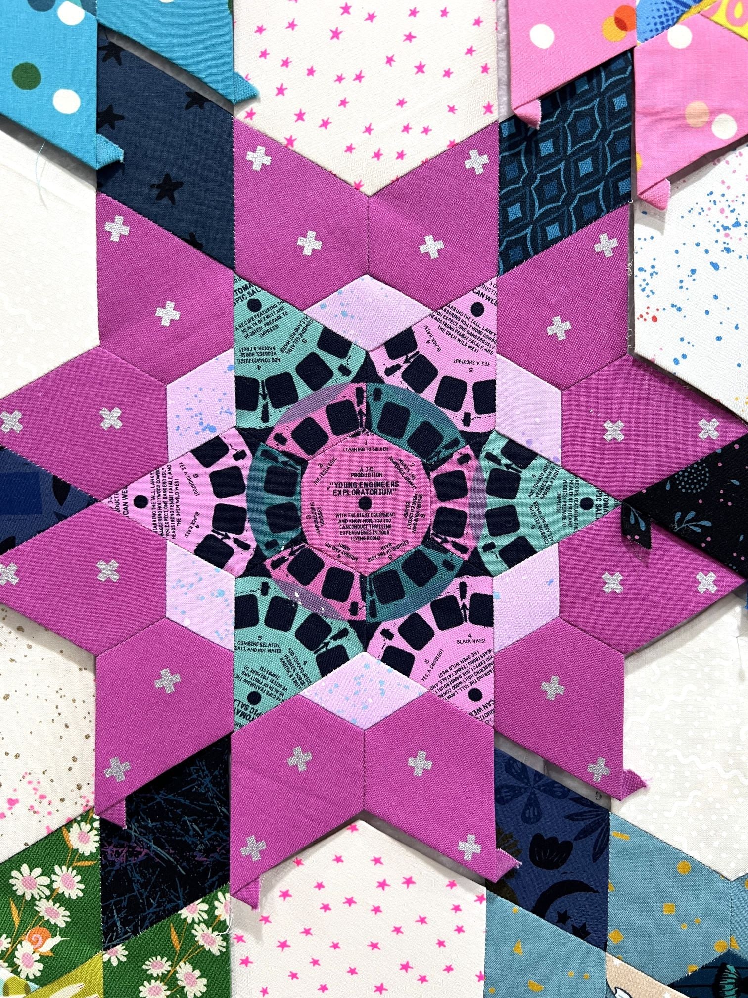Intricate geometric star pattern with pink and black details.