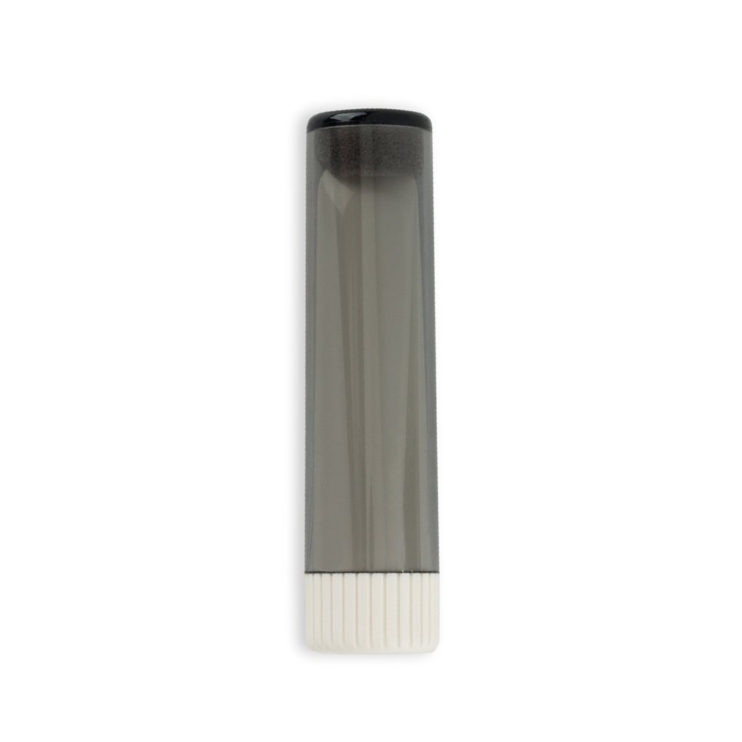 A black and white tube of liquid on top of a table.