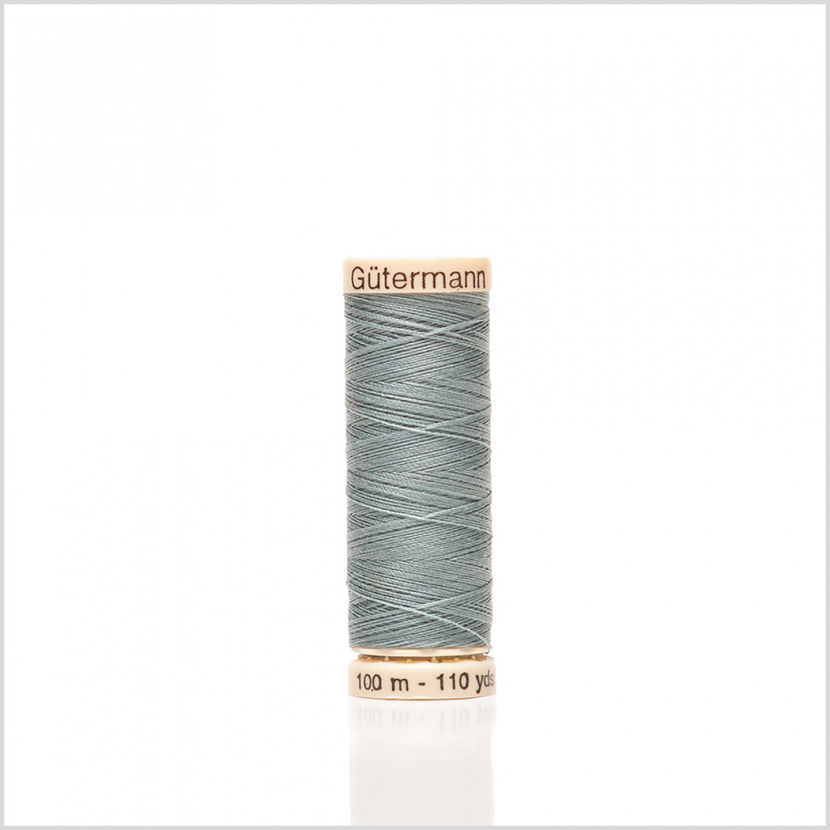 A spool of thread with a wooden holder.
