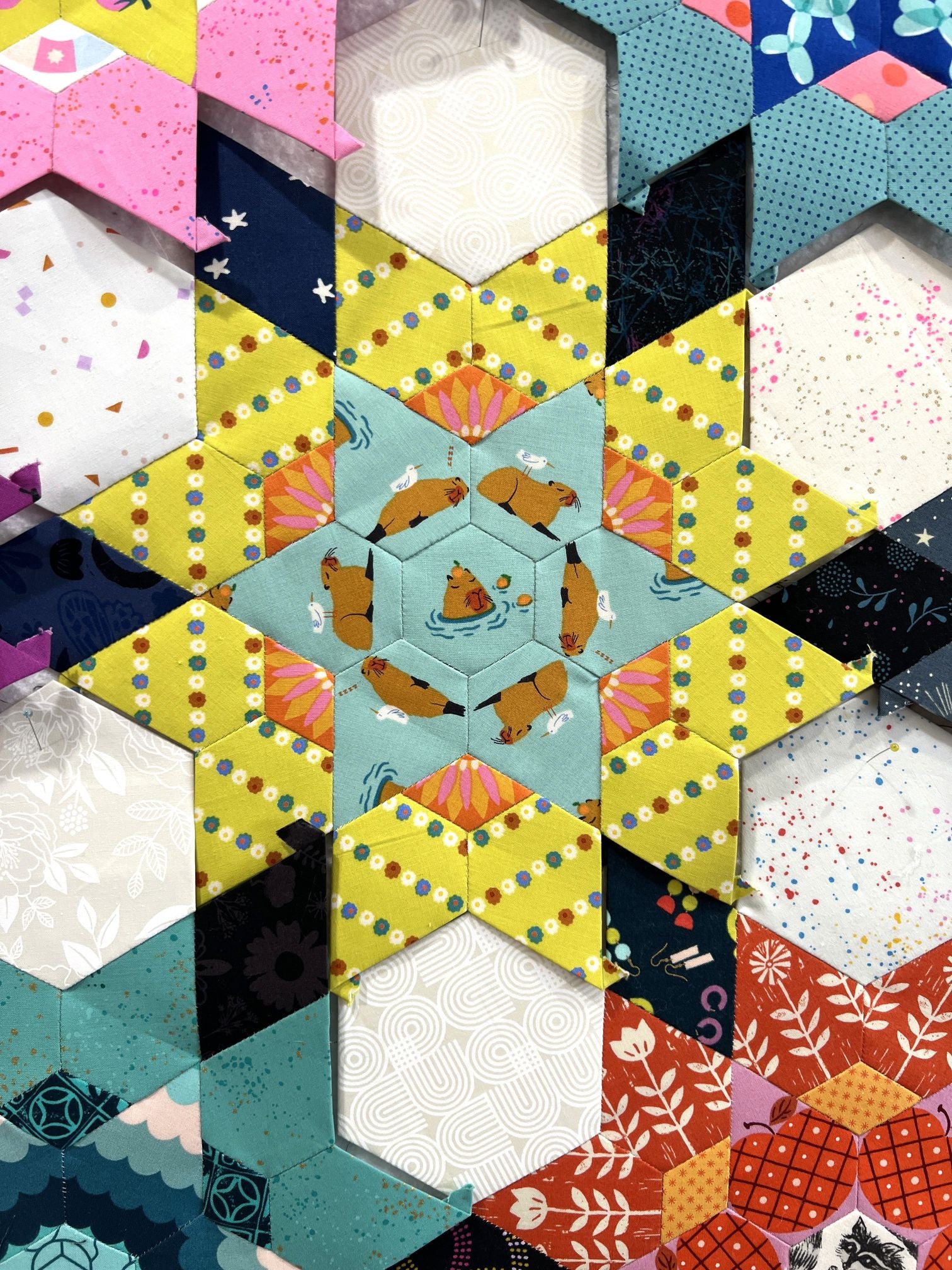 Colorful geometric quilt pattern with stars and triangles.