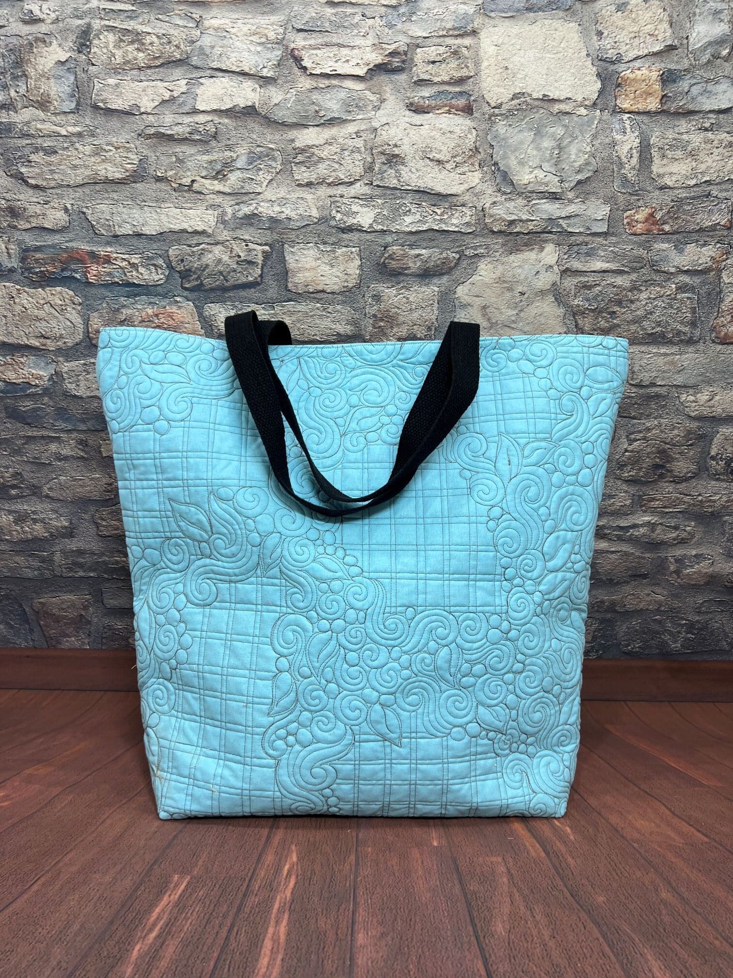 A blue bag sitting on top of the floor.