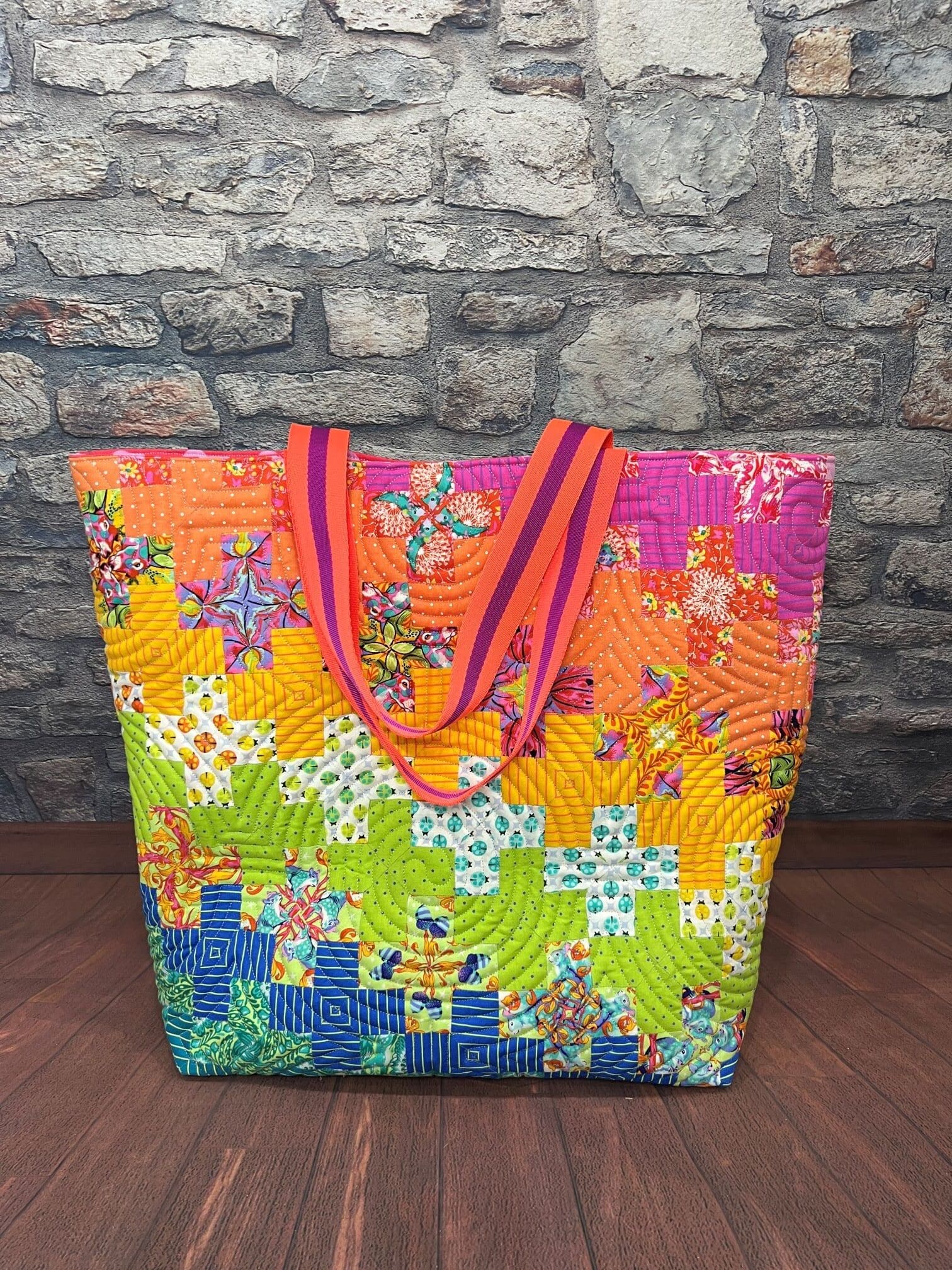 A colorful bag sitting on top of a wooden floor.