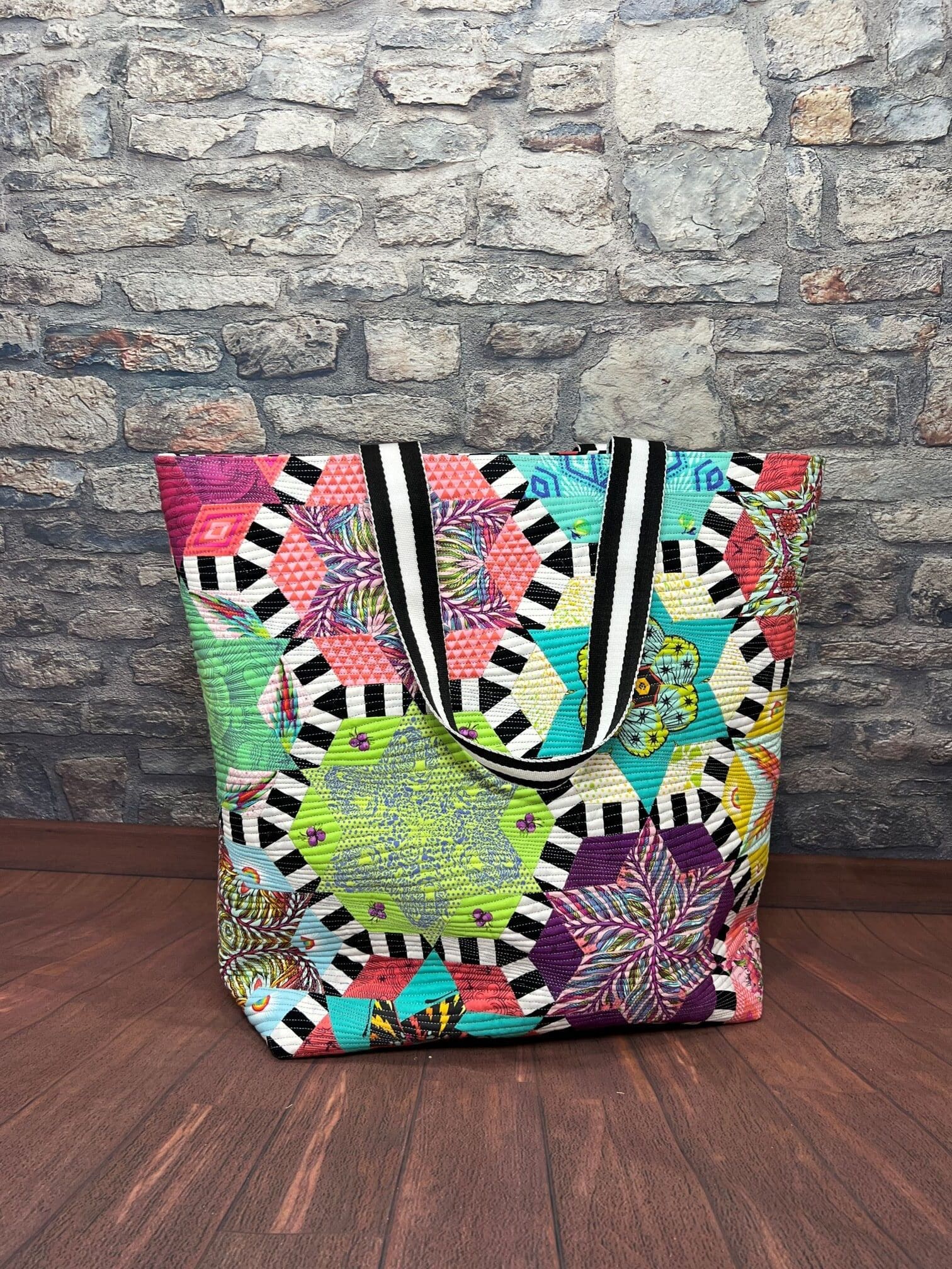 A colorful bag sitting on top of a wooden table.
