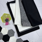 A table with some fabric and a hexagonal tile floor