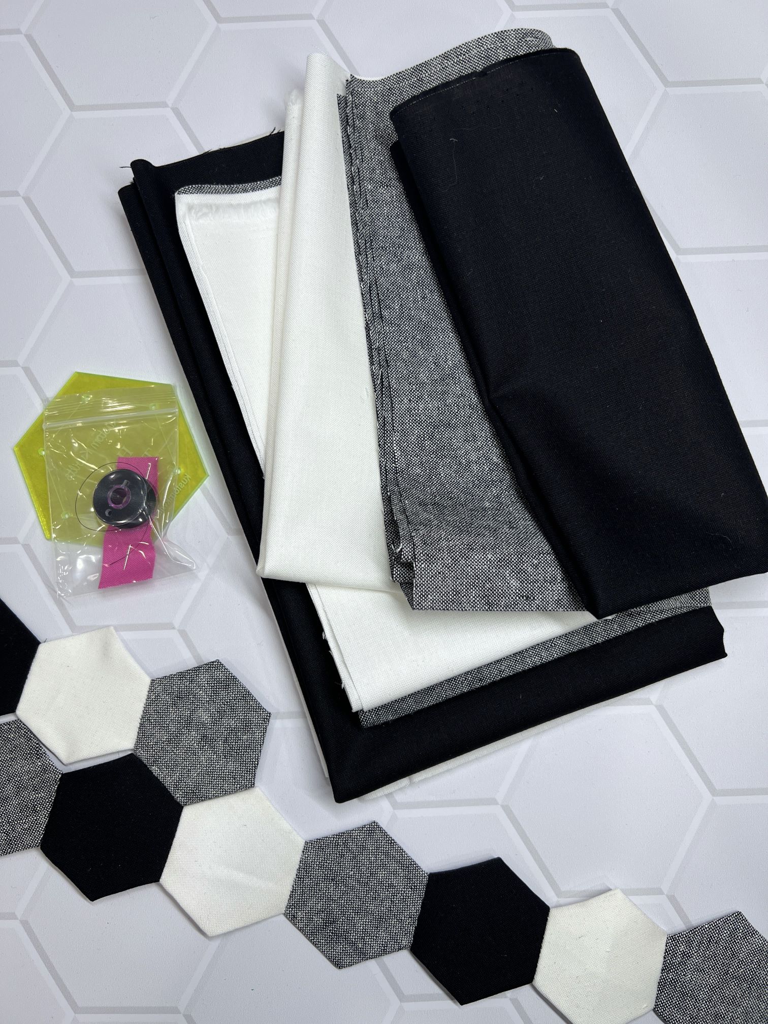 A table with some fabric and a hexagonal tile floor