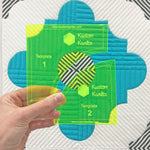 A person holding up two different sized squares.