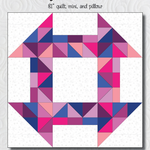 A quilt with a geometric design in pink and blue.