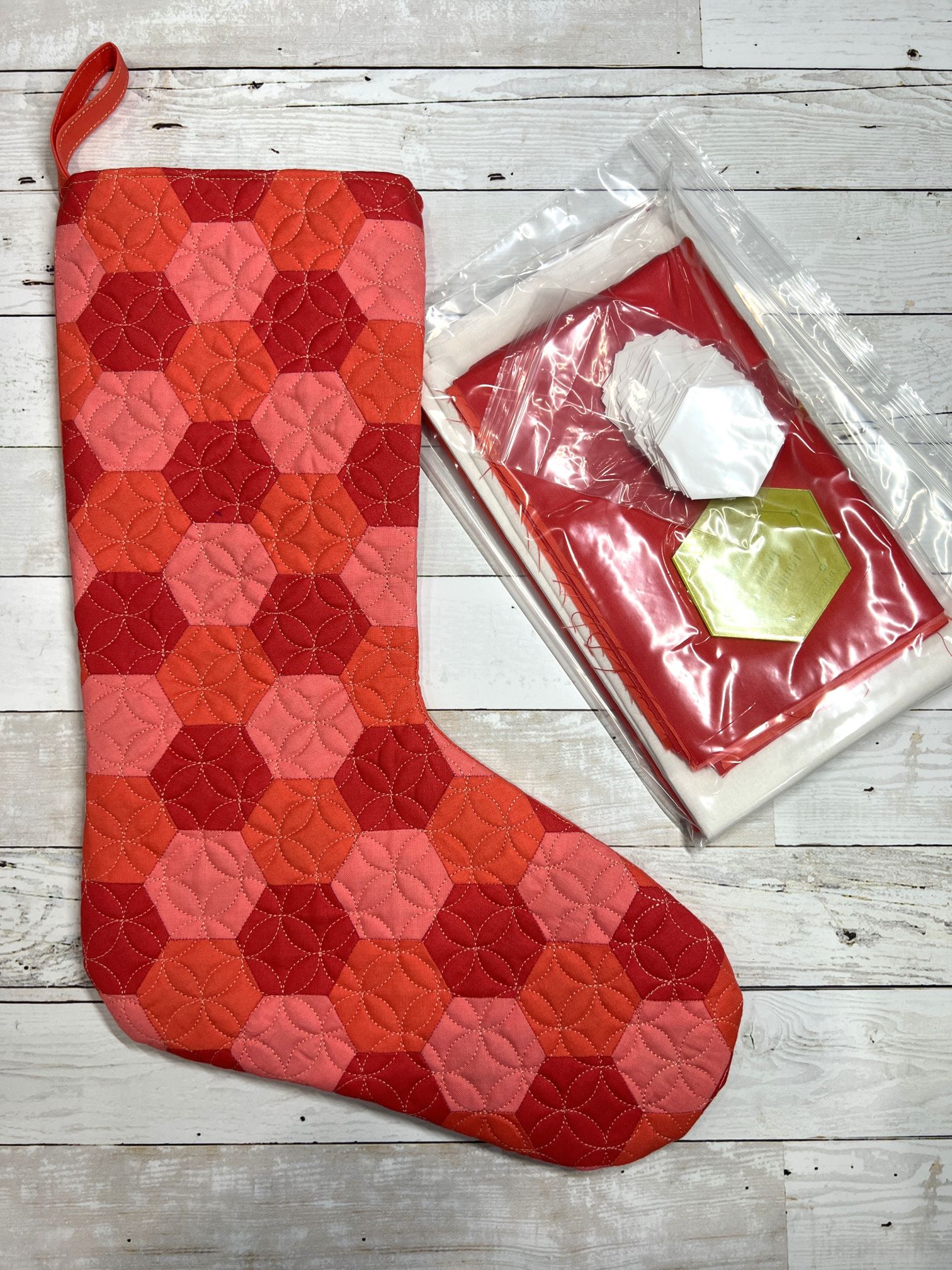 A red and pink stocking next to a box of tissues.