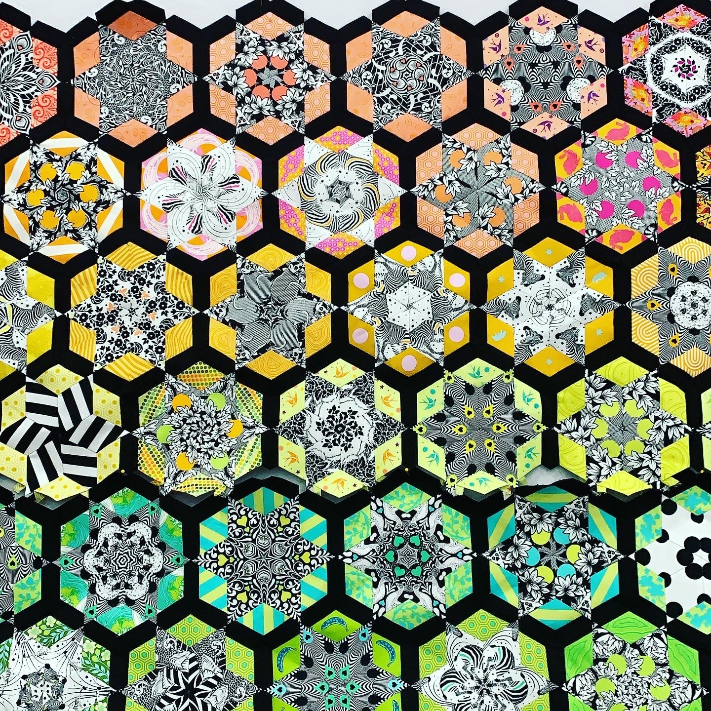 A quilt with many different designs on it.