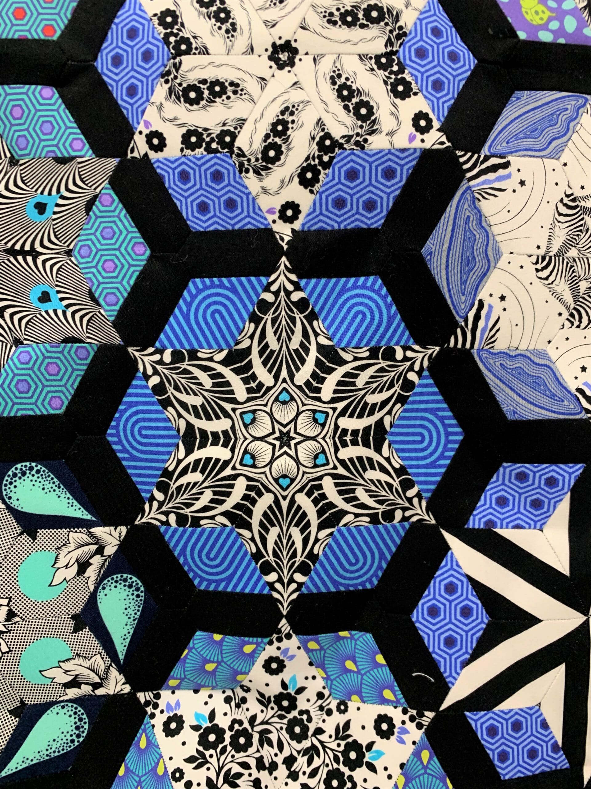 A close up of the hexagonal pattern on a quilt