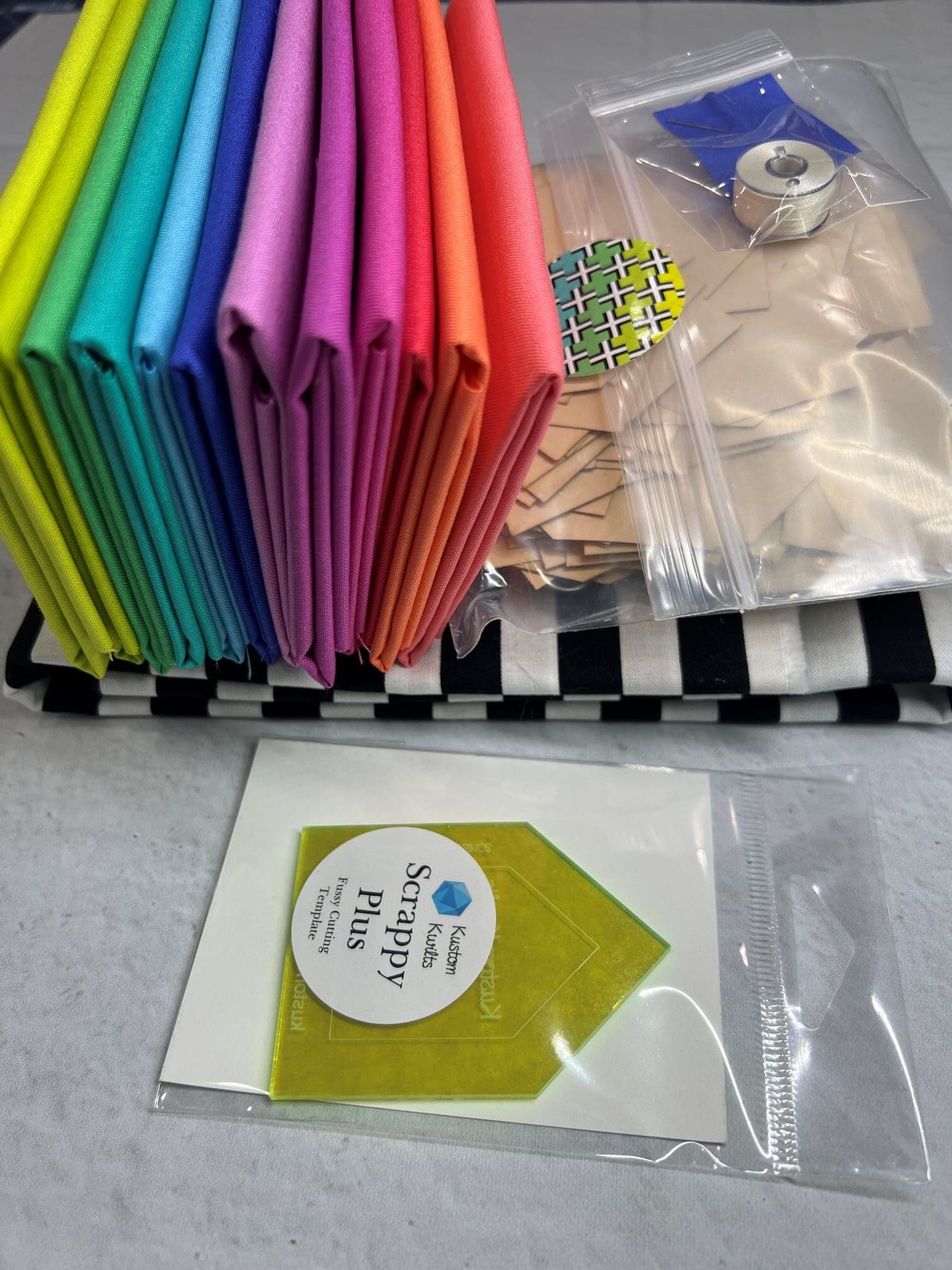 A table with many different colored papers and some bags