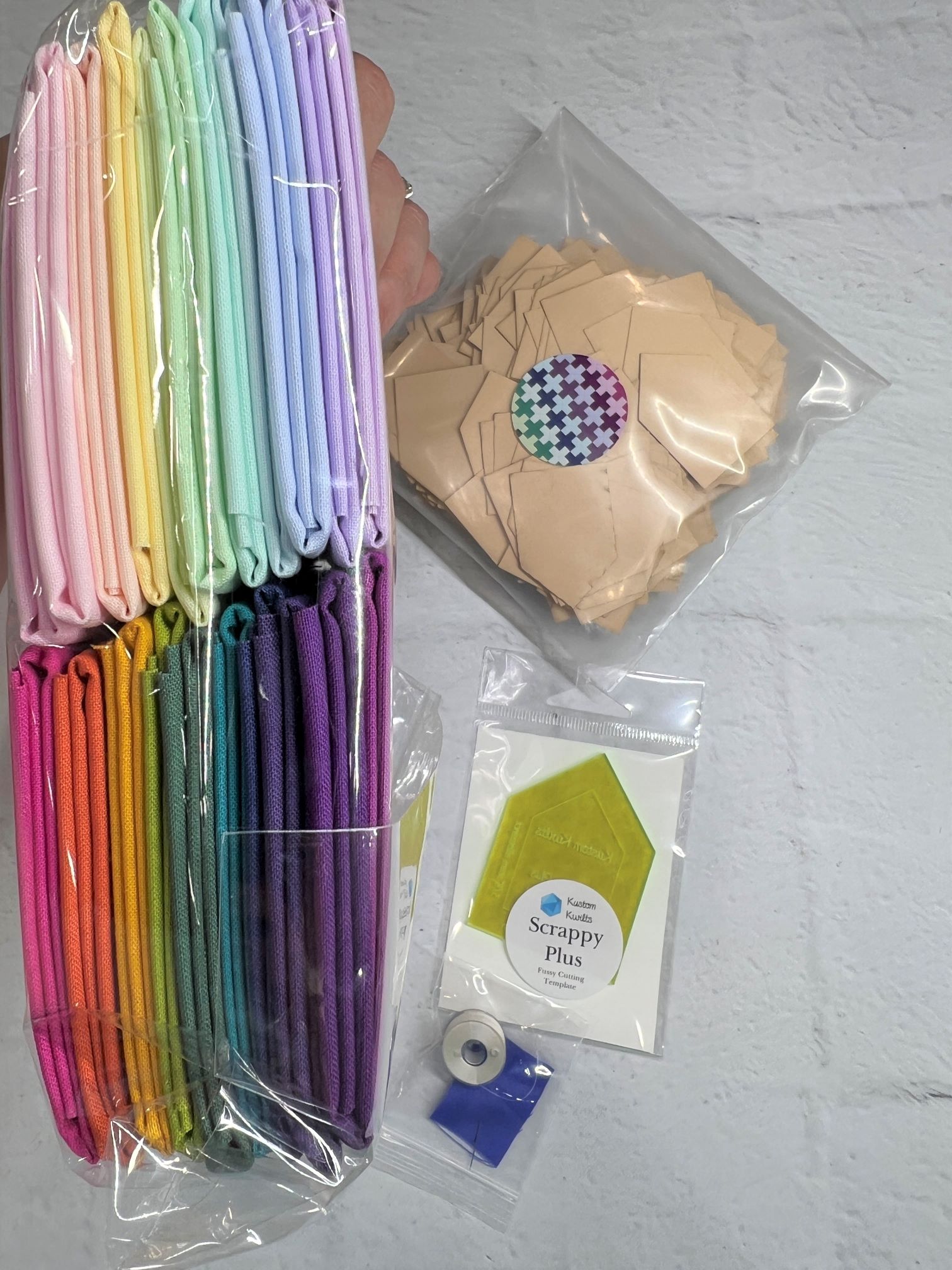 A table with many different colored bags and some paper