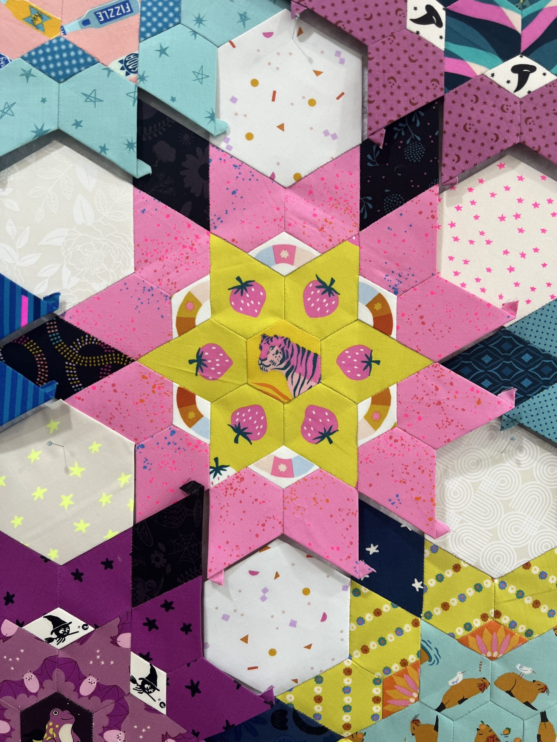 Colorful geometric pattern with hexagons and star shapes.