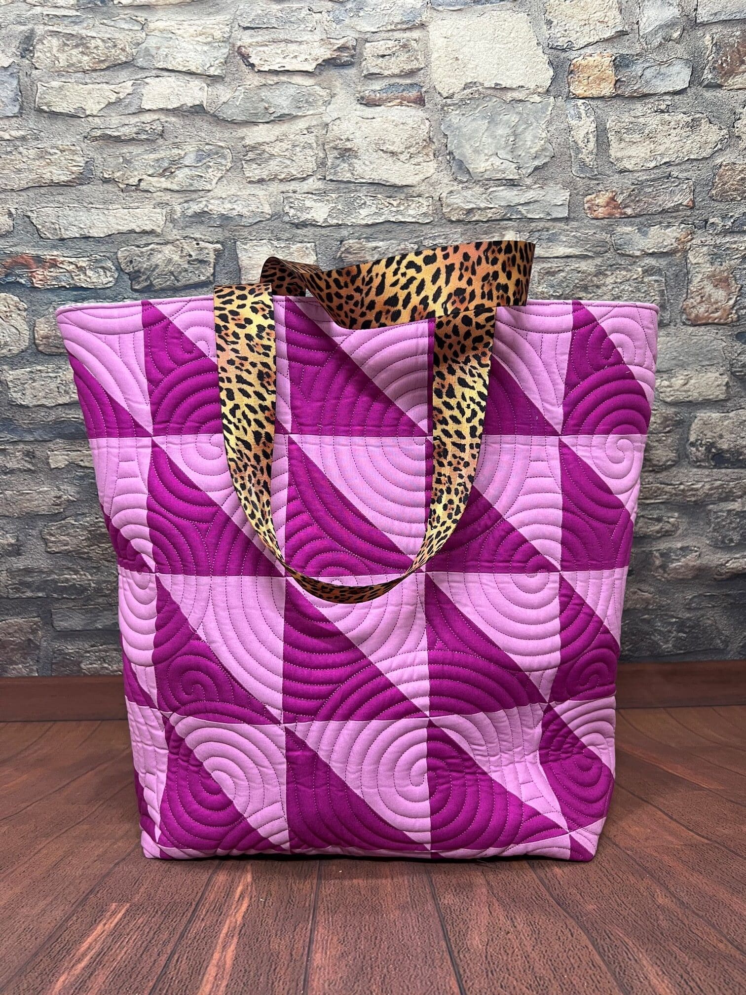 A purple bag with a leopard print handle.