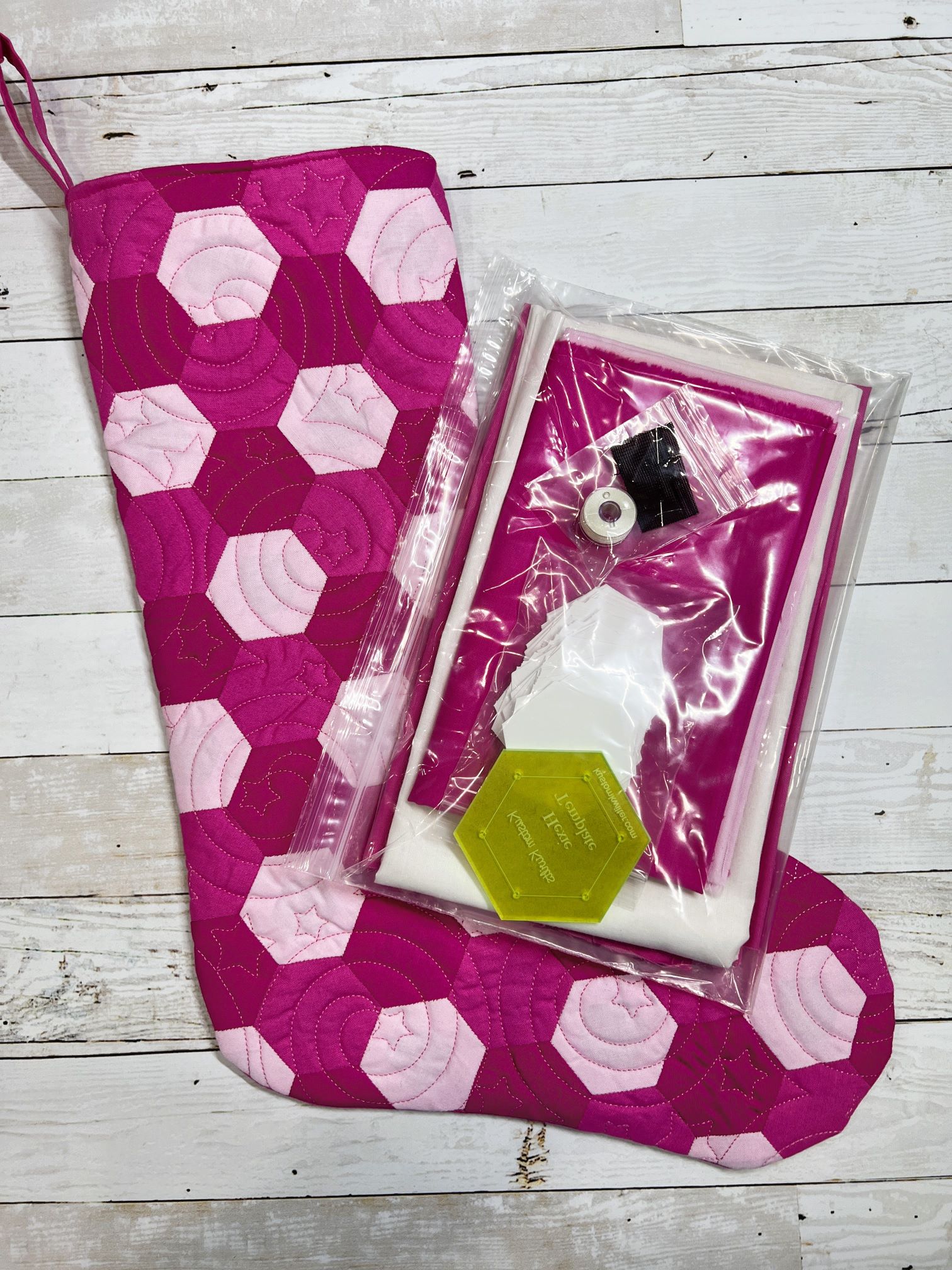 A pink and white stocking with a penguin inside of it.