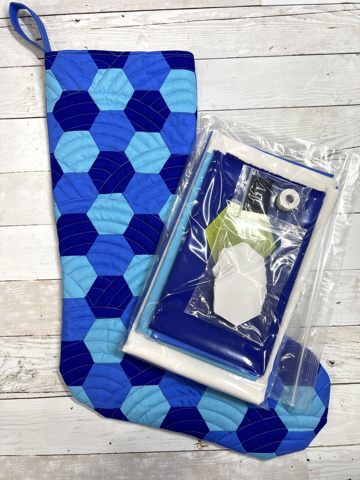 A blue sock with a cell phone inside of it.