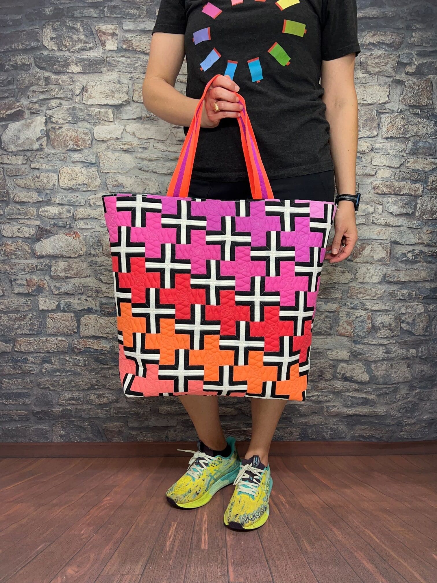A person holding onto a bag with crosses on it