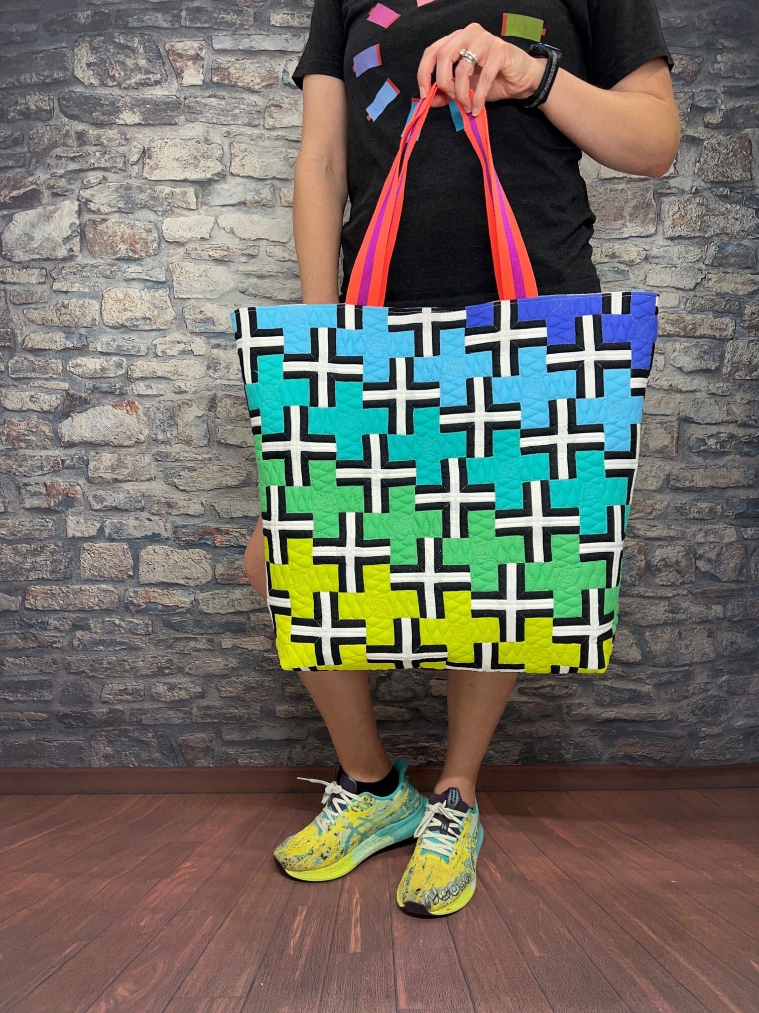 A person holding onto a bag with crosses on it