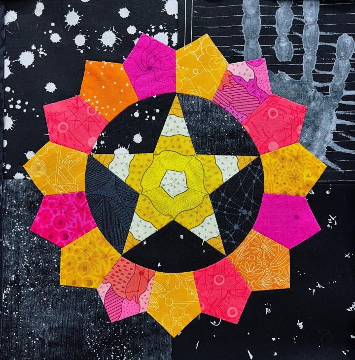 Colorful star and flower pattern on a dark background.