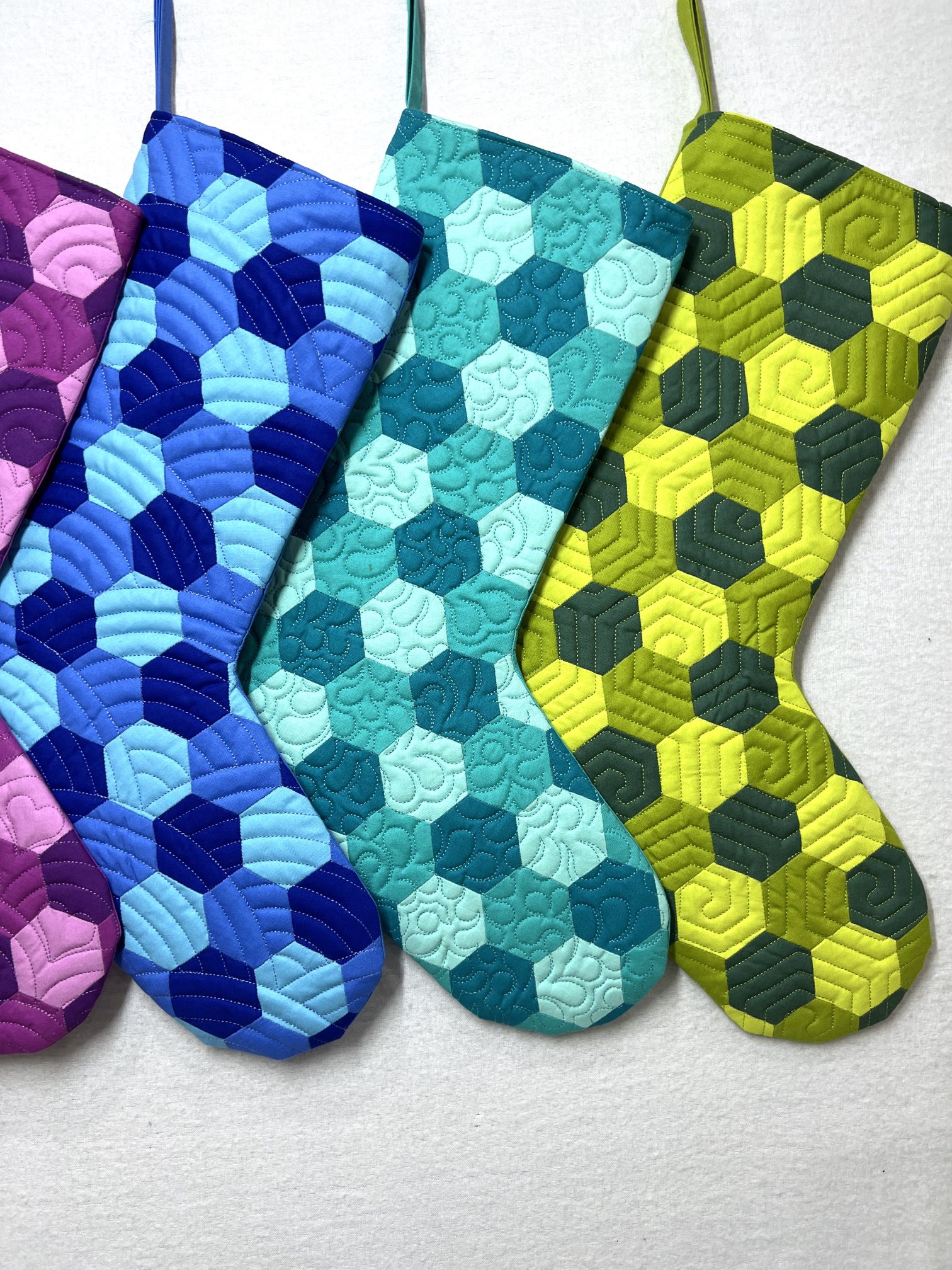 A group of four stockings in different colors.