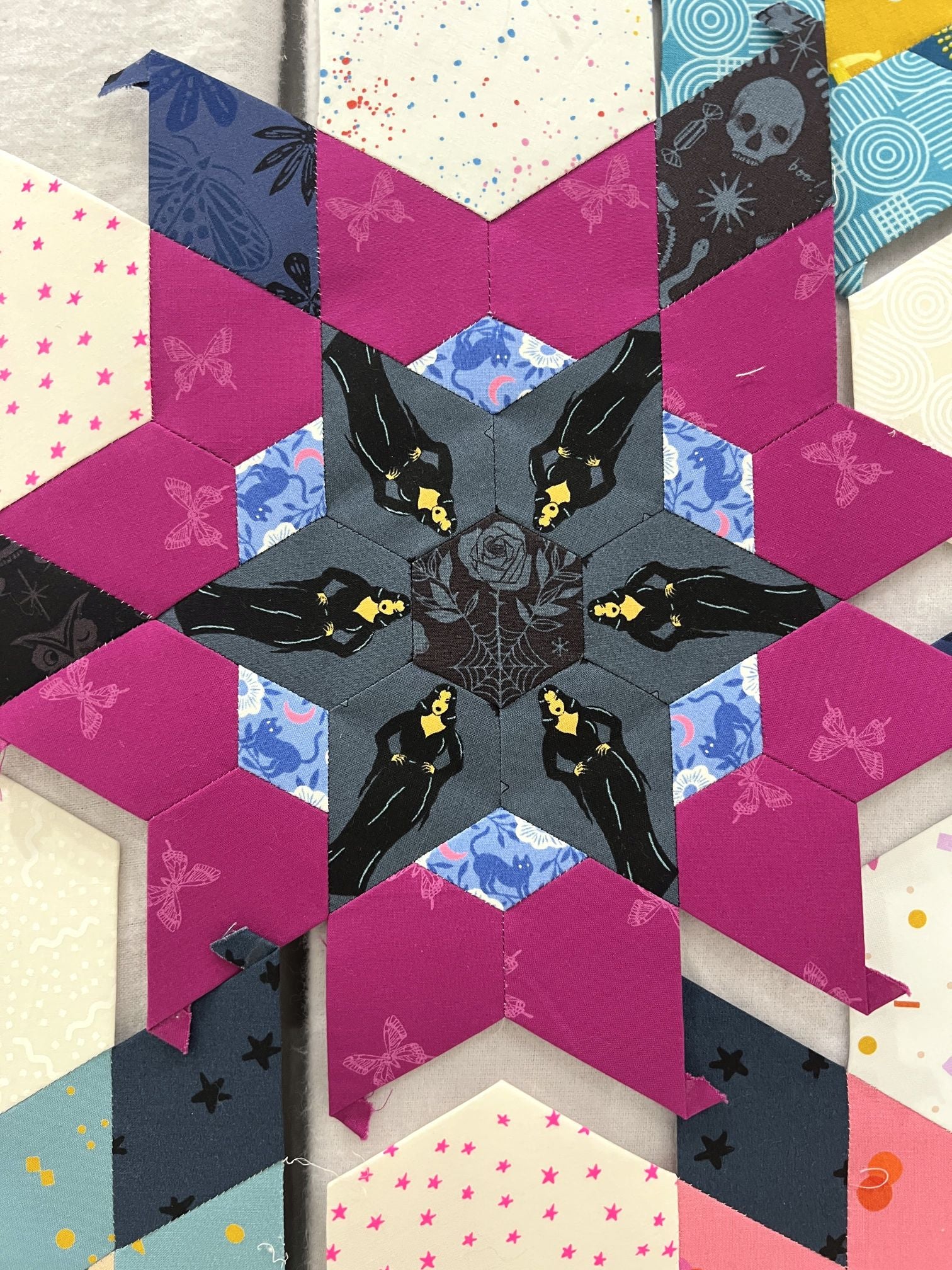 Intricate star-shaped quilt block with geometric patterns and contrasting colors.