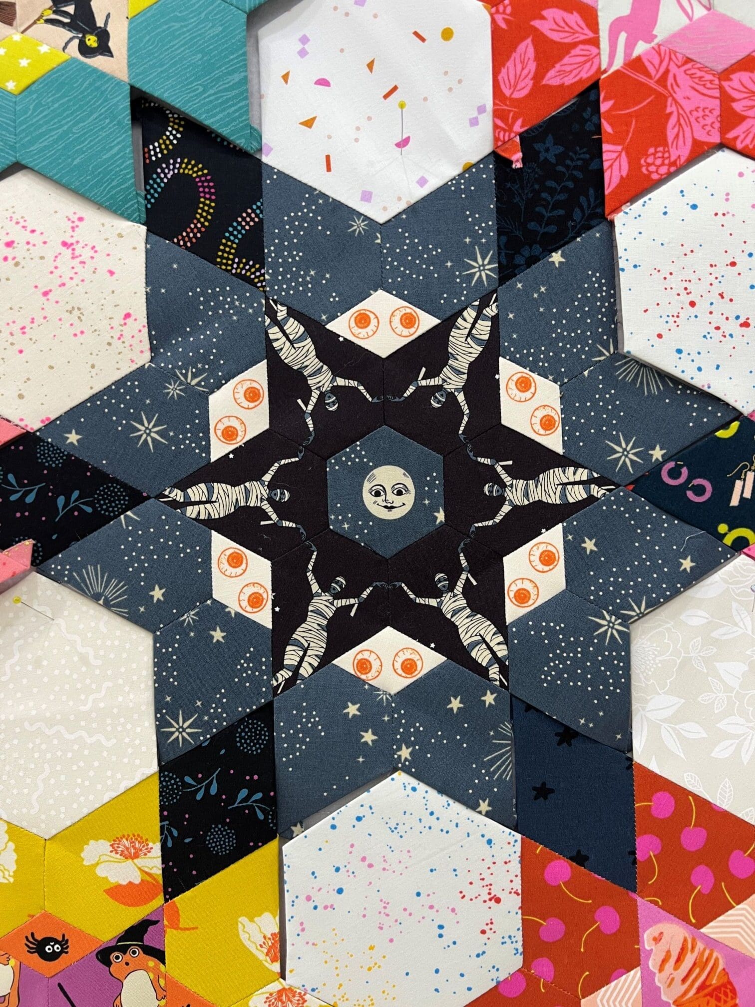 Close-up of a star-shaped quilt with skull and crossbones fabric patterns.