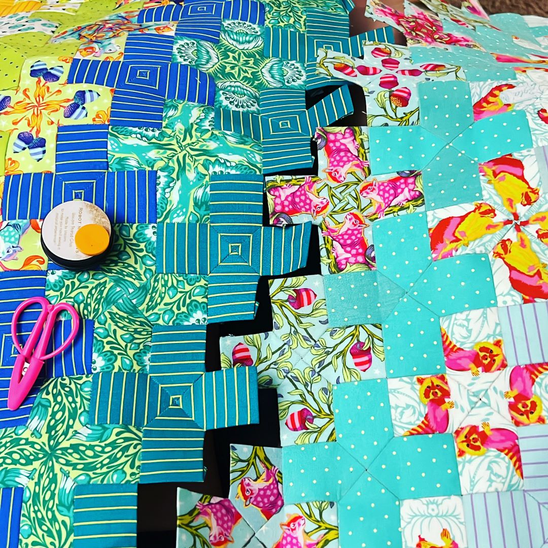 A quilt with many different colors and designs