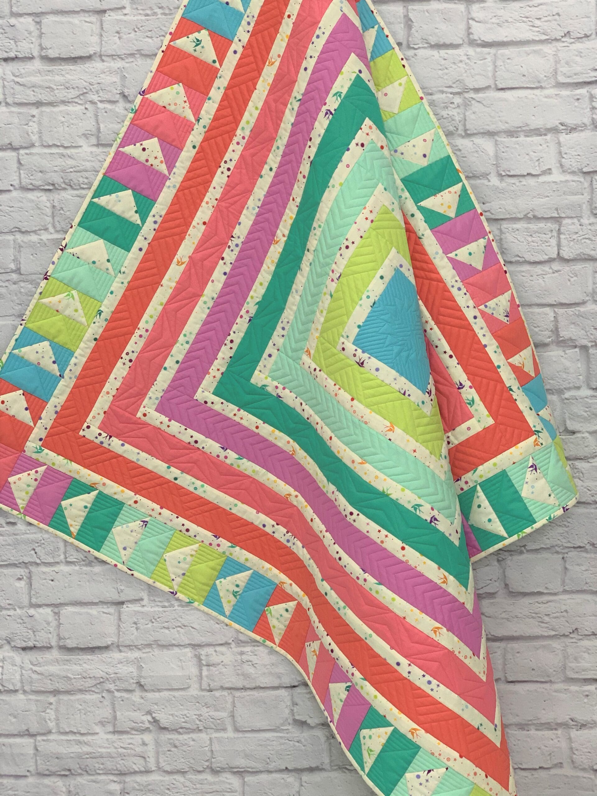 A quilt that is made of different colored squares.