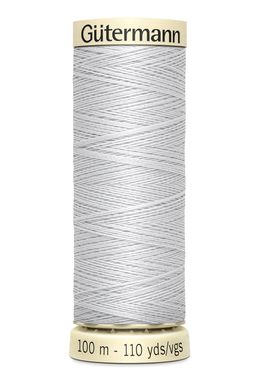 A spool of white thread is shown.